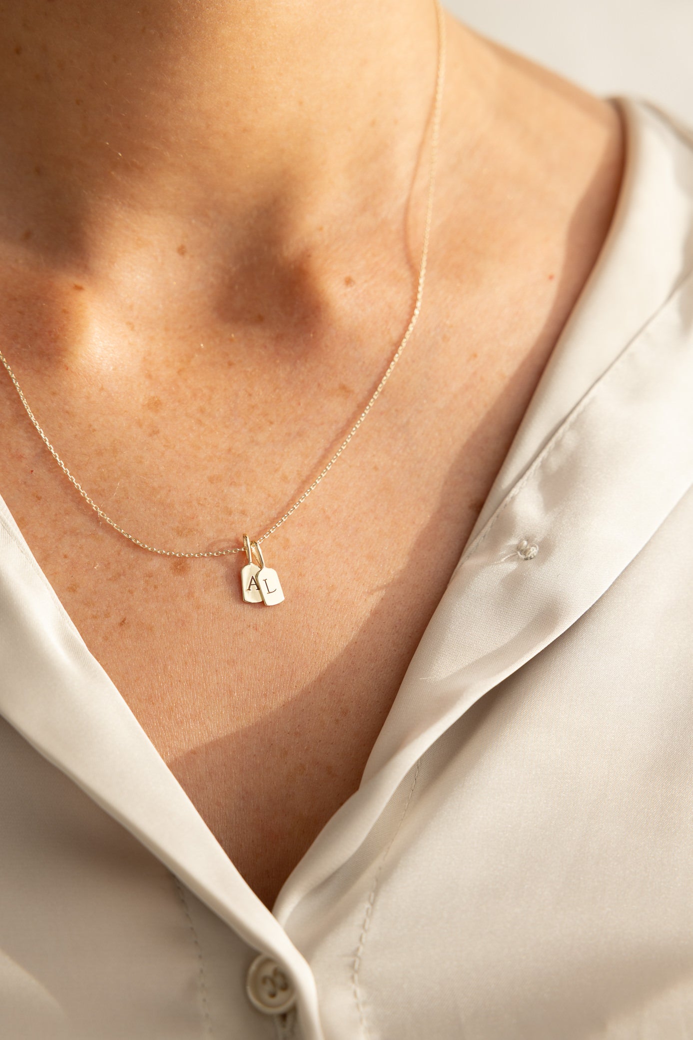 Image of Letter A and L Luna Letter Pendant on Model in sunlight